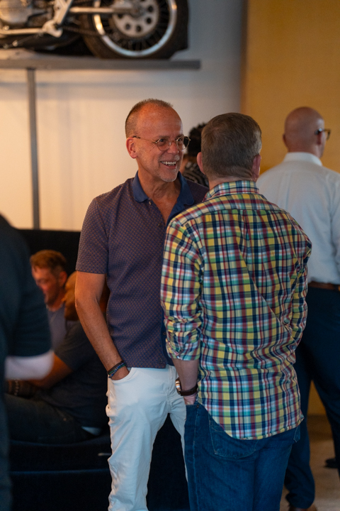 A guest laughing mid-conversation with someone he just met